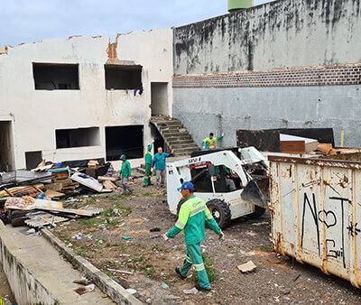 Equipe de limpeza retira sujeira de prédio abandonado, que foi interditado pela Prefeitura (Foto: Eduardo Turati/PMI)